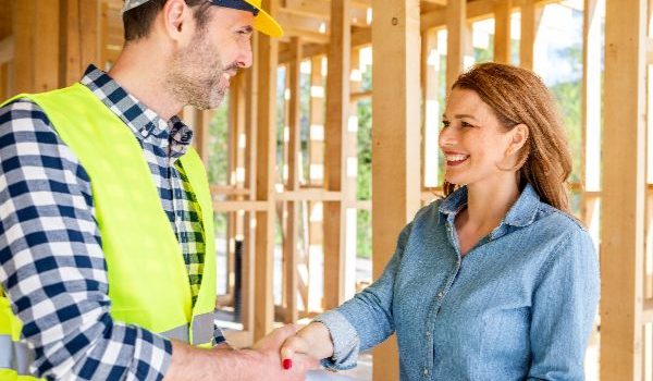 Contruction worker shaking hands with woman